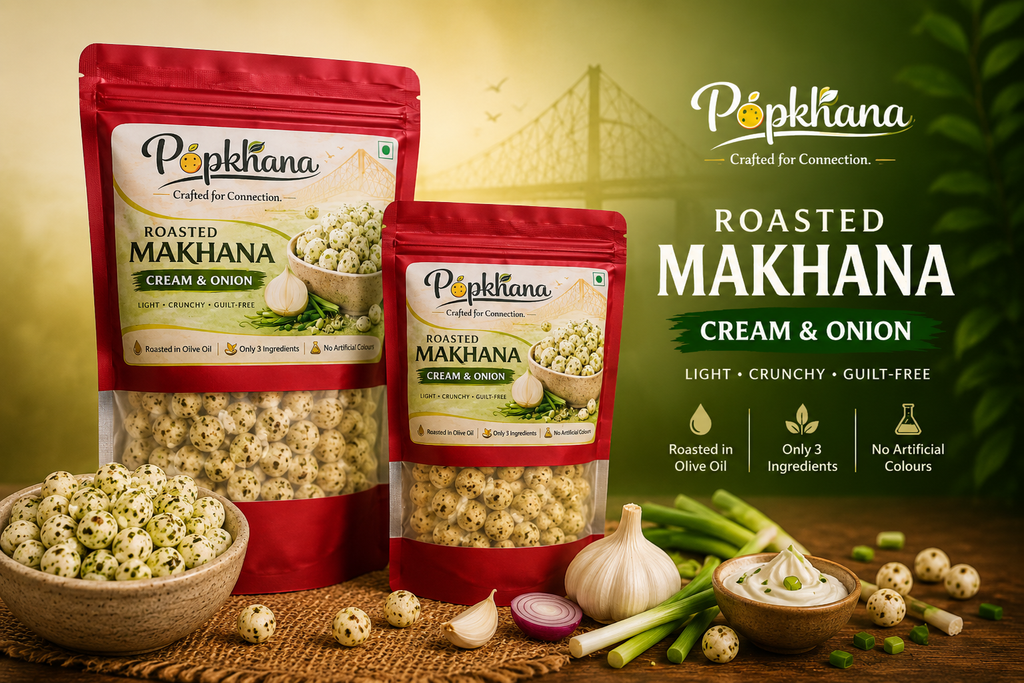 PopKhana Cream & Onion Roasted Makhana lifestyle banner featuring 34g and 70g packs, roasted in olive oil, with spring onions, garlic and creamy dip