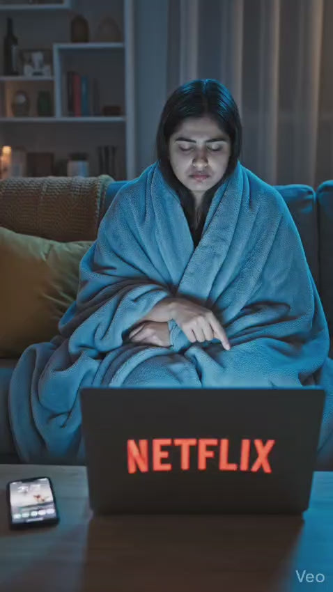 Woman enjoying PopKhana Cream & Onion Roasted Makhana during a movie night, featuring the product pack and snacking moments